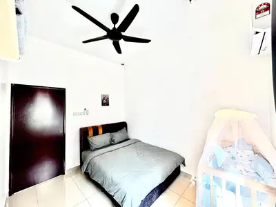 a bedroom with a bed and a ceiling fan at Gioia Home Two Taiping Town in Taiping