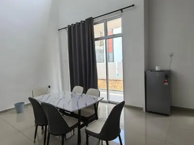 a dining room with a table and chairs and a window at Padang Serai Wangi Roomstay 91 in Padang Serai
