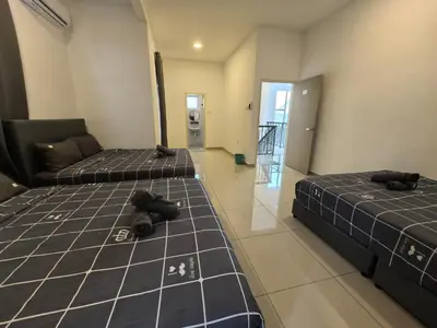 two beds sitting in a room with a hallway at Padang Serai Wangi Roomstay 91 in Padang Serai