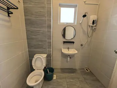 a bathroom with a toilet and a sink at Padang Serai Wangi Roomstay 91 in Padang Serai