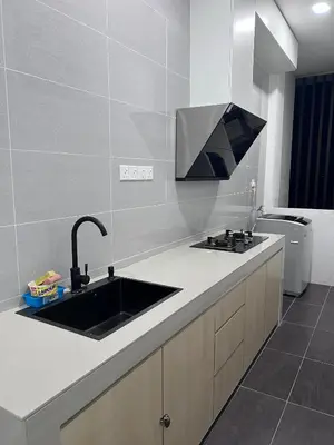 a kitchen with a sink and a counter top at Kuching Town Area Rex apartment in Gua Sai