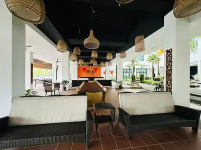 a living room with couches and chairs in a building at Kuching Town Area Rex apartment in Gua Sai