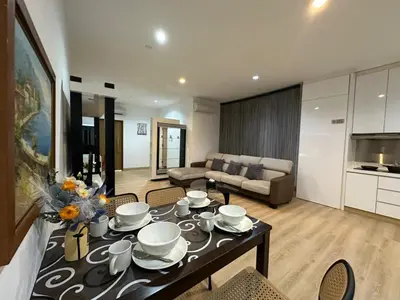 a living room with a table with dishes on it at Spacious Chill Entire Suites 118Island Plaza in George Town