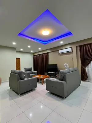 a living room with couches and a blue ceiling at Alma Sweet Home in Bukit Mertajam