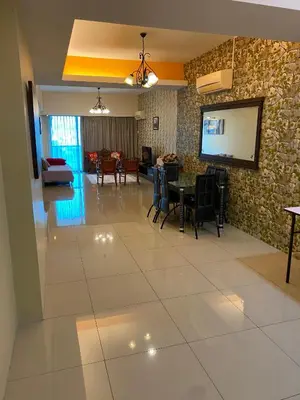 a living room with a table and a tv at 11th Sky Kinta Riverfront with Wi-Fi in Ipoh