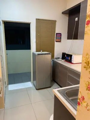 a kitchen with a door leading into a kitchen with a sink at 11th Sky Kinta Riverfront with Wi-Fi in Ipoh