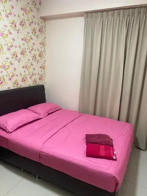 a pink bed in a room with a window at 11th Sky Kinta Riverfront with Wi-Fi in Ipoh