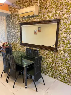 a conference room with a table and chairs in front of a stone wall at 11th Sky Kinta Riverfront with Wi-Fi in Ipoh