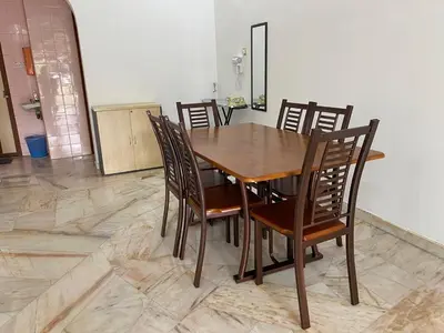 a wooden table and chairs in a room at Staycation Taiping Homestay in Taiping