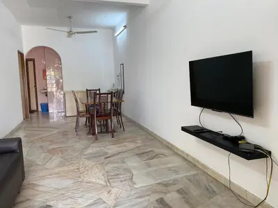 a living room with a flat screen tv on a wall at Staycation Taiping Homestay in Taiping