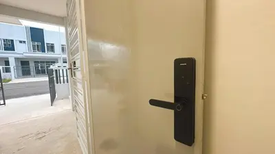 an open door with a black door handle on a door at 2 Bedroom Townhouse Homestay In Bandar Dato Onn in Gua Sai