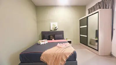 a bedroom with a large bed and a large mirror at 2 Bedroom Townhouse Homestay In Bandar Dato Onn in Gua Sai