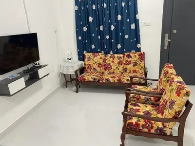 a living room with a couch and a tv at Homestay Aman Berkat in Kampar