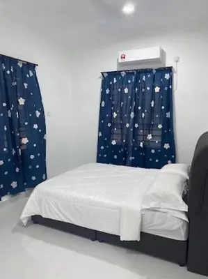 a bedroom with a bed and curtains with planets at Homestay Aman Berkat in Kampar
