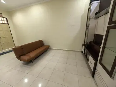 a living room with a couch and a tv at Lagenda Serai Wangi Homestay in Padang Serai