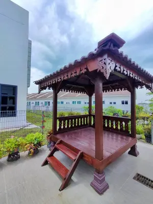 a wooden gazebo with a bench on a patio at 2Op Ipoh, Semi D, in Ipoh