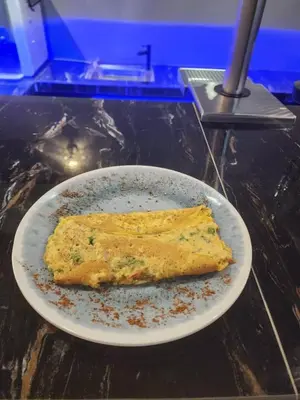 a piece of food on a plate on a table at Captain Hotel Cafe & Bistro in Sitiawan