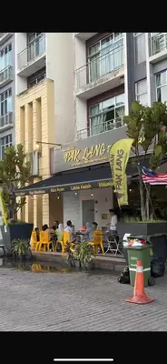 a restaurant with yellow tables and chairs in front of a building at Lily Studio in Brinchang