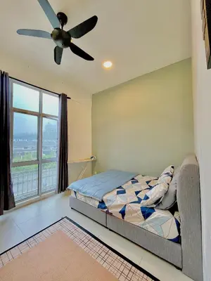 a bedroom with a bed and a ceiling fan at Lily Studio in Brinchang