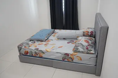 a bed sitting on the floor in a room at Homestay Behrang Sentral in Kampung Behrang