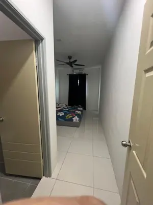 a hallway with a bed and a ceiling fan at Homestay Behrang Sentral in Kampung Behrang