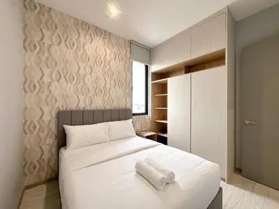 a bedroom with a bed with two towels on it at Iconic Regency by Li in Gelugor