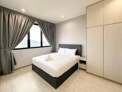 a bedroom with a bed and a large window at Iconic Regency by Li in Gelugor