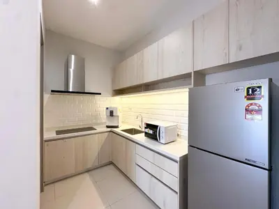a kitchen with a refrigerator and a microwave at Iconic Regency by Li in Gelugor