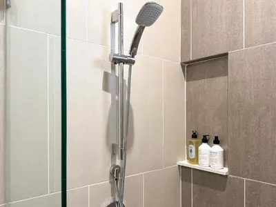 a shower with a shower head in a bathroom at Iconic Regency by Li in Gelugor