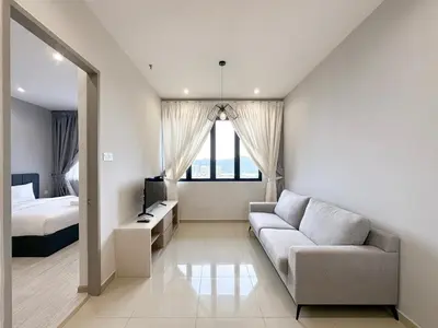 a living room with a couch and a bed at Iconic Regency by Li in Gelugor