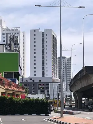 a city street with tall buildings in the background at The Sun Executive Suite - Dolphin's Home in Bayan Lepas