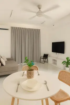 a white living room with a table and chairs at The Sun Executive Suite - Dolphin's Home in Bayan Lepas