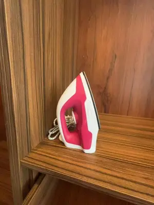 a red and white object sitting on a wooden shelf at Mansion One studio in George Town