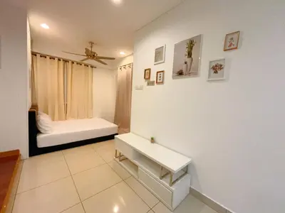 a white room with a bench and a bed at Mansion One studio in George Town
