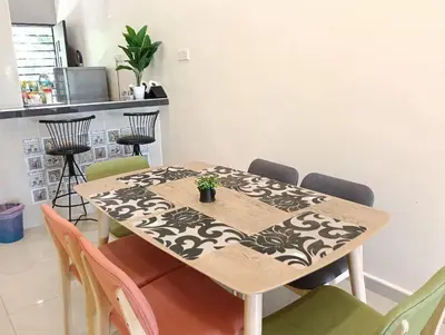 a dining room table with a table cloth on it at Azzahra Homestay in Permatang Pauh