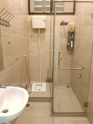 a bathroom with a shower and a sink at Azzahra Homestay in Permatang Pauh