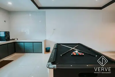 a pool table in the middle of a room at Ipoh Lazy Private Club House 4B3B by Verve 14 pax in Tambun