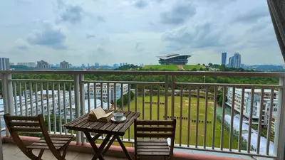 a table and chairs on a balcony with a view at PPAM Seruling Presint 5, Putrajaya 4BR with PICC View and Garden View Homestay