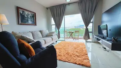 a living room with a couch and a television at PPAM Seruling Presint 5, Putrajaya 4BR with PICC View and Garden View Homestay