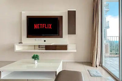a living room with a tv on a wall at Lotus Lake Sanctuary Homestay Taiping With Netflix -1 Carpark in Taiping
