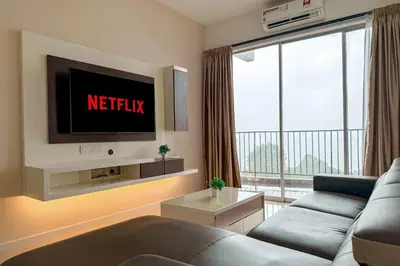 a living room with a couch and a tv at Lotus Lake Sanctuary Homestay Taiping With Netflix -1 Carpark in Taiping