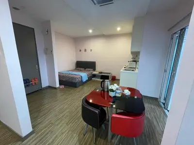 a small room with a table and a bed at Neamat