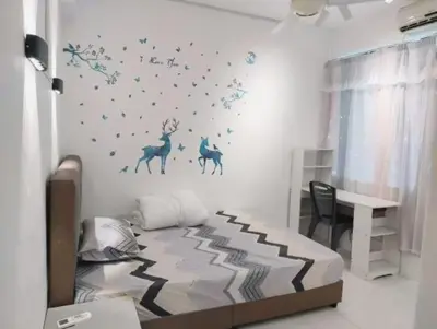 a bedroom with a bed with blue stars on the wall at Comfy Room Near to Penang Bridge in George Town