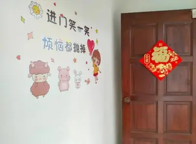 a door with a wall with hello kitty stickers on it at Comfy Room Near to Penang Bridge in George Town
