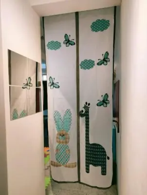 a room with a curtain with a giraffe and butterflies at Comfy Room Near to Penang Bridge in George Town