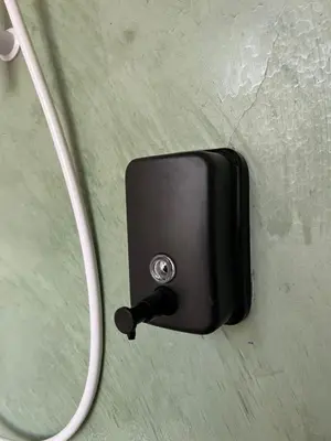 a black switch with a cord hanging on a wall at Carnarvon 73 in George Town