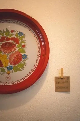 a plate hanging on a wall with a sign on it at Carnarvon 73 in George Town