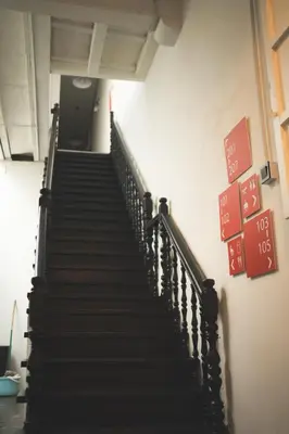 a staircase in a building with signs on the wall at Carnarvon 73 in George Town