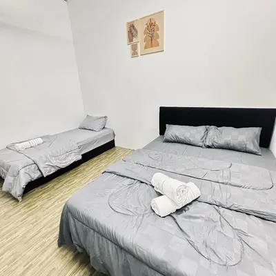 a bedroom with two beds with towels on them at Hey Rest Up with shared bathroom in Ipoh
