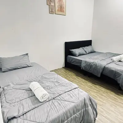 a bedroom with two beds and a bedskirts at Hey Rest Up with shared bathroom in Ipoh